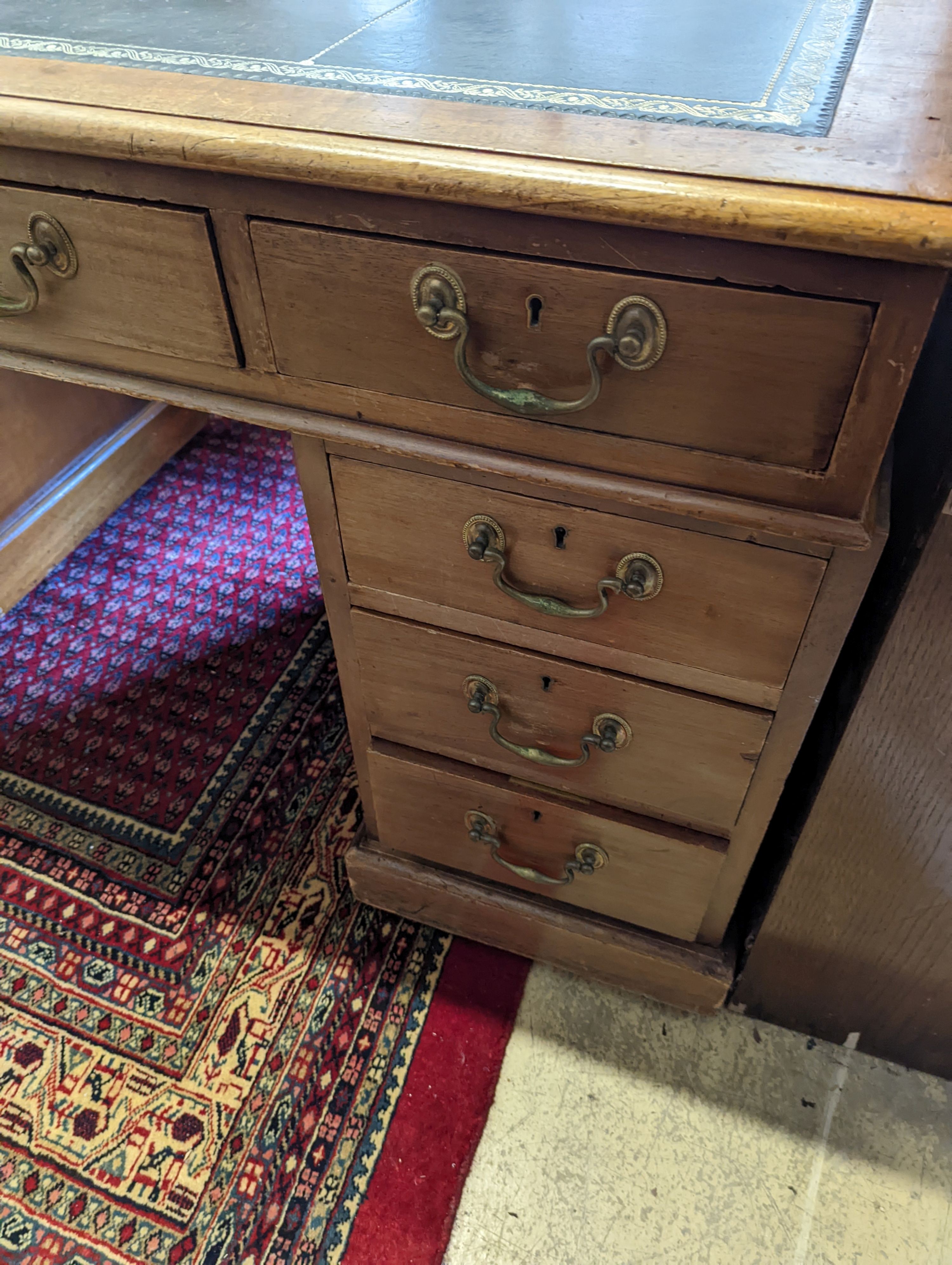 An Edwardian faded mahogany pedestal desk, stamped T. Willson, Great Queen Street, London, length 136cm, depth 76cm, height 76cm